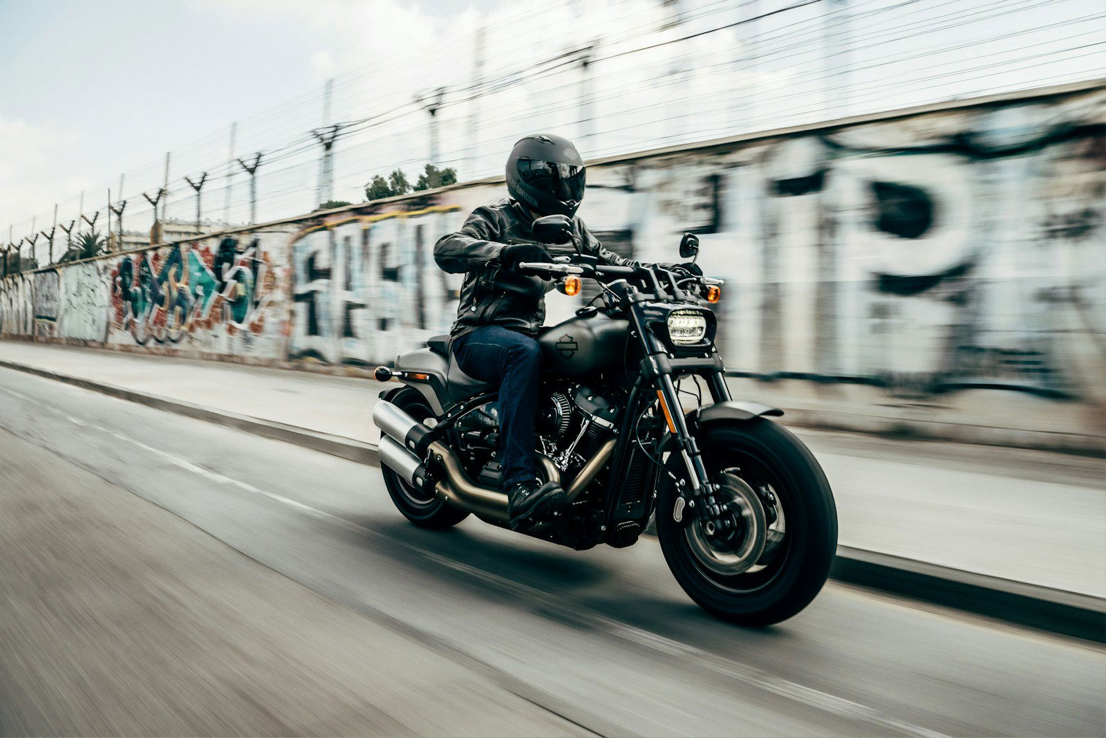 Photo by Harley-Davidson person riding motorcycle on concrete road