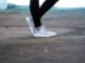 shallow focus photo of person wearing gray running shoes