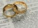 two gold-colored rings on paper