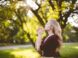 woman praying under tree during daytime
