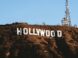 the hollywood sign is covered in dirt on top of a hill