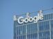 A tall building with the google logo on top of it