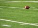 A football laying on a football field