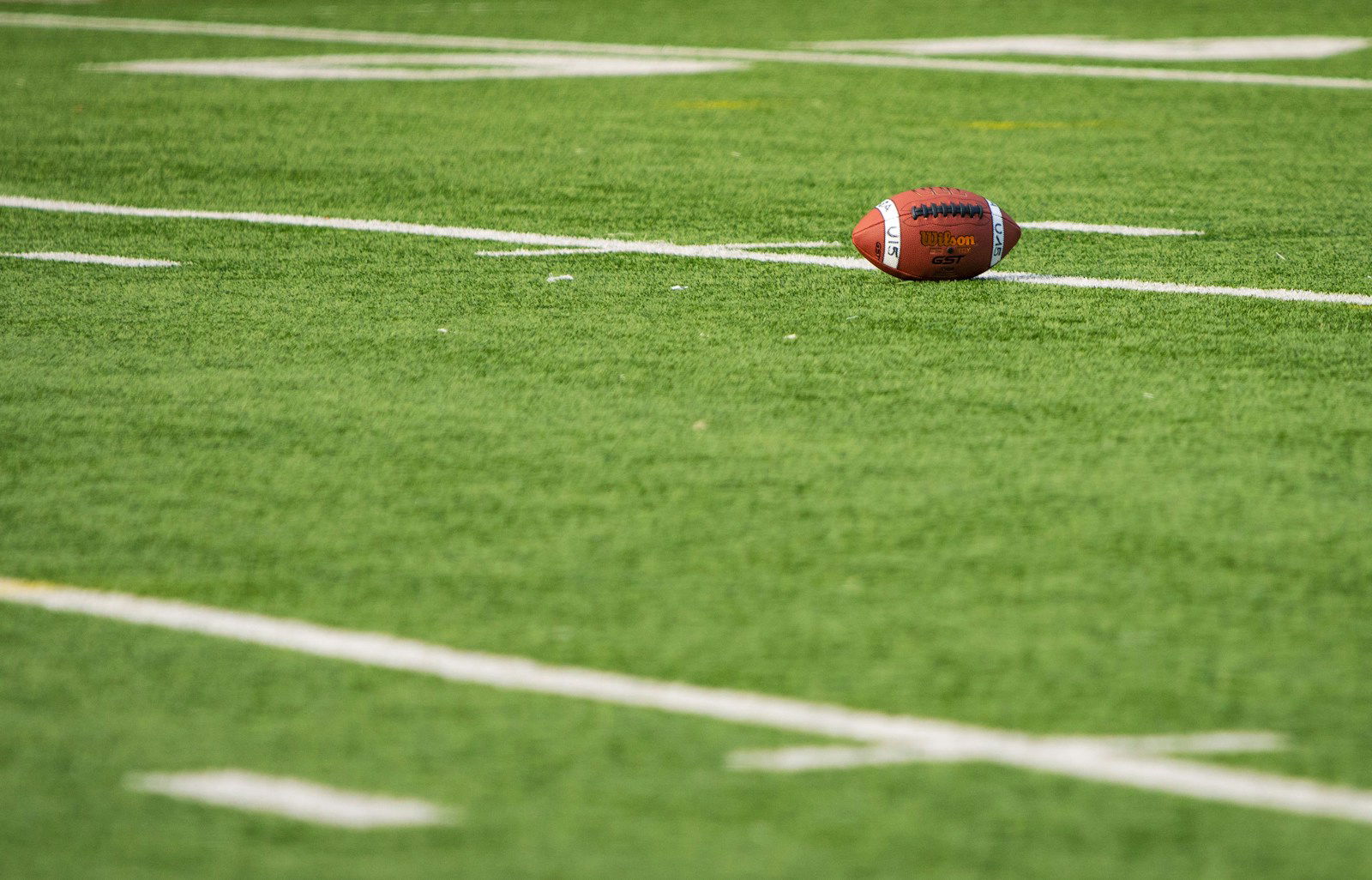 Photo by Paolo Aldrighetti A football laying on a football field