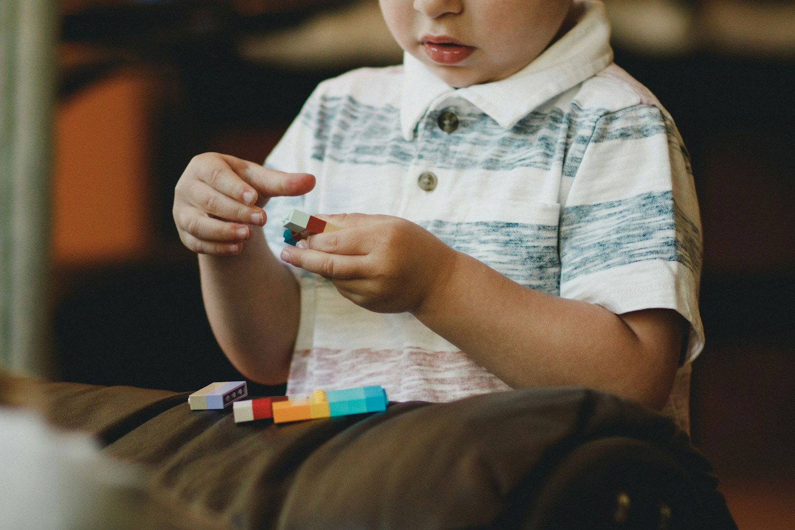 Photo by Caleb Woods boy holding block toy