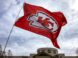 a kansas chiefs flag flying in front of a building