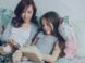 Mom and daughter read a book together.