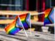 two rainbow flags sitting on top of a wooden table