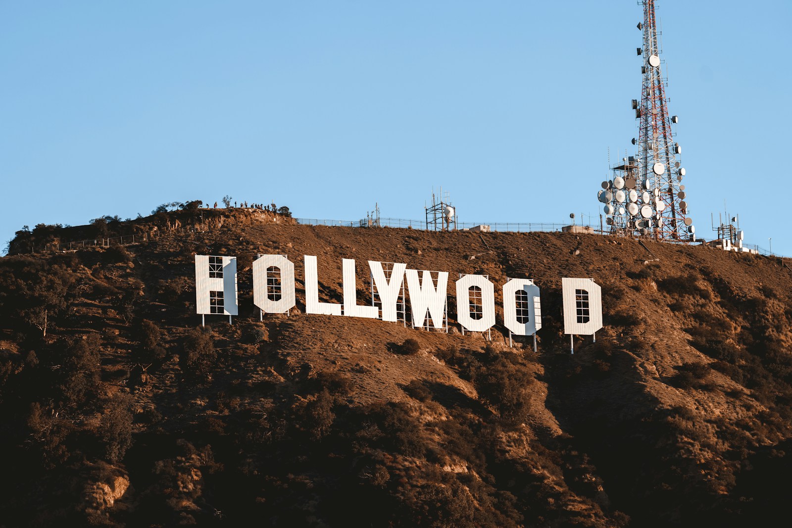 the hollywood sign is covered in dirt on top of a hill