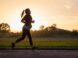 woman in black sports bra and black pants running on water during sunset